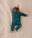 Baby wearing a lightweight ergoPouch Long Sleeve Layer 0.2 TOG Ocean Blue, having tummy time