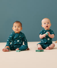 Baby wearing a lightweight ergoPouch Long Sleeve Layer 0.2 TOG Ocean Blue