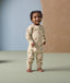Smiling toddler in ergoPouch Long Sleeve Layer 1.0 TOG Savannah