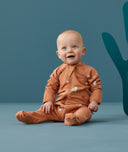 Baby wearing a lightweight ergoPouch Long Sleeve Layer 0.2 TOG Sunny