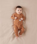 Newborn baby wearing an ergoPouch Long Sleeve Layer 0.2 TOG Sunny