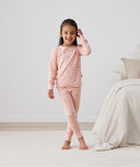 Big kid wearing 2-piece ergoPouch Long Sleeve Pyjamas 1.0 TOG Daisies