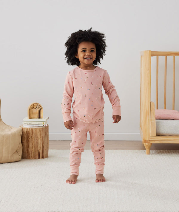 Toddler wearing 2-piece ergoPouch Long Sleeve Pyjamas 2.0 TOG Daisies