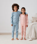 Big kids wearing 2-piece ergoPouch Long Sleeve Pyjamas 2.0 TOG Dragonflies