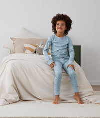Big kid wearing an ergoPouch Long Sleeve Pyjamas 2.0 TOG Dragonflies