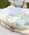Baby inside a in an ergoPouch Easy Sleep Portable Crib with the mosquito net closed