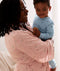 Mum wearing a an ergoPouch Matchy Matchy Robe Daisies, holding a child