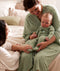 Mum wearing a an ergoPouch Matchy Matchy Robe Willow, holding a baby in a matching Layer