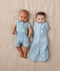 Two babies, one wearing a Cocoon Swaddle Bag 1.0 TOG Dragonflies and the other in a Layer