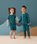 Preschooler wearing 2-piece ergoPouch Long Sleeve Pyjamas 0.2 TOG Ocean Blue for summer