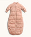 Peach-colored quilted baby sleep suit bag with long sleeves and front zipper, featuring a subtle all-over animal print.