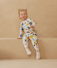 Toddler wearing a warm, ergoPouch Sleep Onesie 3.5 TOG Fruit Salad
