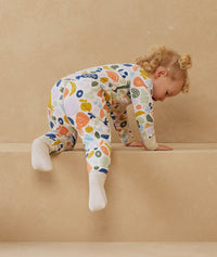 Toddler wearing a warm, ergoPouch Sleep Onesie 3.5 TOG Fruit Salad
