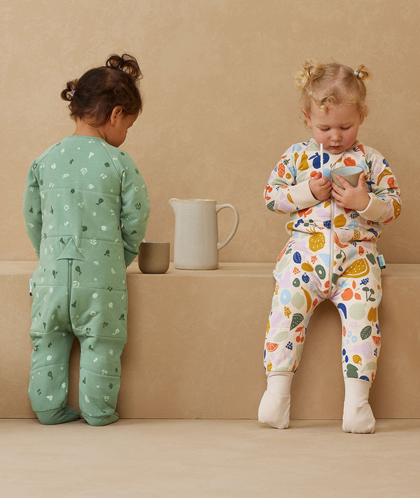 Toddler wearing a warm, ergoPouch Sleep Onesie 3.5 TOG Fruit Salad