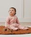Baby wearing an ergoPouch Sleep Onesie 2.5 TOG Daisies