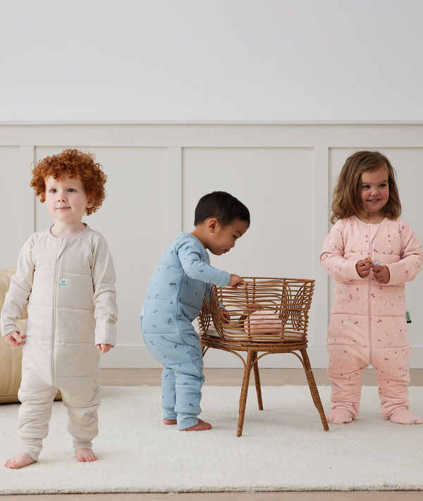 Toddler wearing a warm, ergoPouch Sleep Onesie 3.5 TOG Oatmeal Marle