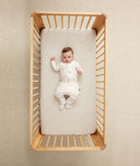 Baby wearing an ergoPouch Sleep Onesie 2.5 TOG Oatmeal Marle