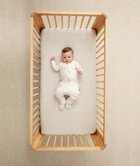 Baby wearing an ergoPouch Sleep Onesie 2.5 TOG Oatmeal Marle