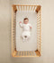 Baby wearing an ergoPouch Sleep Onesie 2.5 TOG Oatmeal Marle