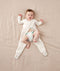 Baby wearing an ergoPouch Sleep Onesie 2.5 TOG Oatmeal Marle, getting nappy changed