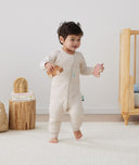Toddler wearing an ergoPouch Sleep Onesie 2.5 TOG Oatmeal Marle