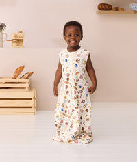 Toddler smiling wearing ergoPouch Jersey Sleep Suit Bag 0.2 TOG in Bon Appetit