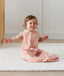 Toddler wearing ergoPouch Sleep Suit Bag 0.2 TOG Daisies