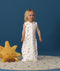 Smiling toddler wearing an ergoPouch Jersey Sleep Suit Bag 0.2 TOG Daydream, a sleeping bag that converts to a sleep suit with legs