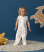 Smiling toddler wearing an ergoPouch Jersey Sleep Suit Bag 0.2 TOG Daydream, a sleeping bag that converts to a sleep suit with legs