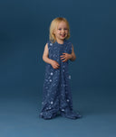 Smiling toddler wearing an ergoPouch Jersey Sleep Suit Bag 0.2 TOG Starbeam, a sleeping bag that converts to a sleep suit with legs.