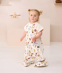 Toddler standing looking at the camera wearing ergoPouch Sleep Suit bag 1.0 TOG Bon Appetit