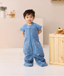 Toddler standing looking at the camera wearing ergoPouch Sleep Suit bag 1.0 TOG Petit Pretzel