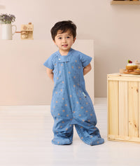 Toddler standing looking at the camera wearing ergoPouch Sleep Suit bag 1.0 TOG Petit Pretzel