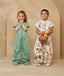 Two preschool kids wearing a TOG-rated ergoPouch sleep suit bag, featuring cute, colourful prints.