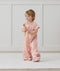 Toddler wearing an ergoPouch Sleep Suit Bag 1.0 TOG Daisies