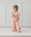 Toddler wearing an ergoPouch Sleep Suit Bag 1.0 TOG Daisies