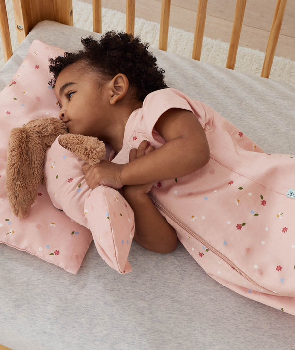 ergoPouch Organic Toddler Pillow And Case Daisies with toddler in matching sleepwear