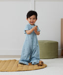 Toddler wearing an ergoPouch Sleep Suit Bag 1.0 TOG Dragonflies