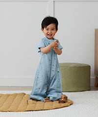Toddler wearing an ergoPouch Sleep Suit Bag 1.0 TOG Dragonflies