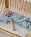 Toddler wearing an ergoPouch Sleep Suit Bag 1.0 TOG Dragonflies