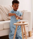 Toddler wearing an ergoPouch Sleep Suit Bag 1.0 TOG Dragonflies