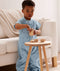 Toddler wearing an ergoPouch Sleep Suit Bag 1.0 TOG Dragonflies