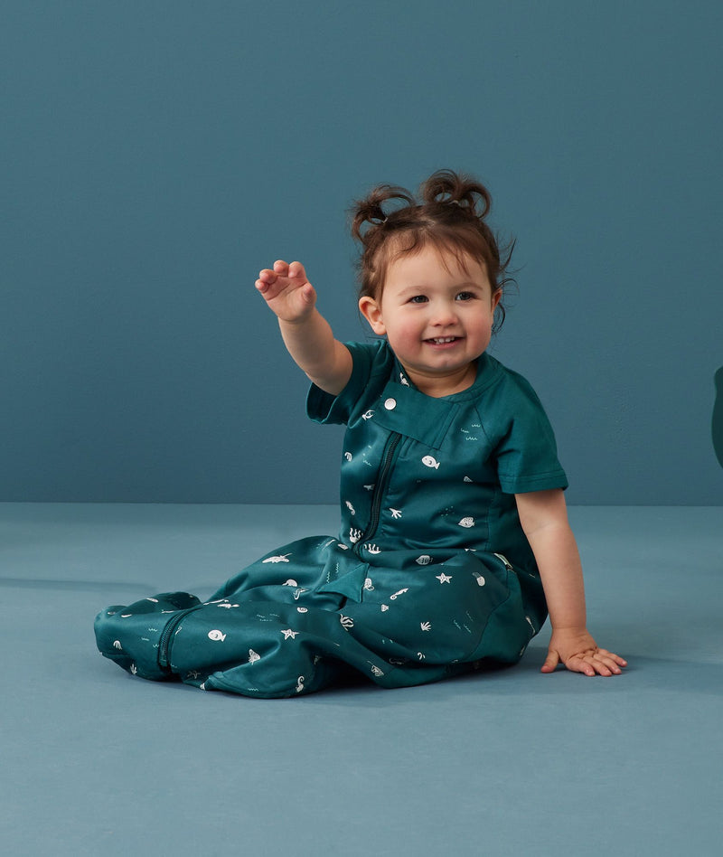 Toddler wearing an ergoPouch Sleep Suit Bag 1.0 TOG Ocean Blue