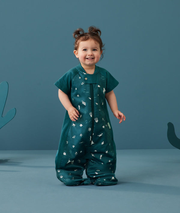 Toddler wearing an ergoPouch Sleep Suit Bag 1.0 TOG Ocean Blue