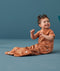 Toddler wearing an ergoPouch Sleep Suit Bag 1.0 TOG Sunny