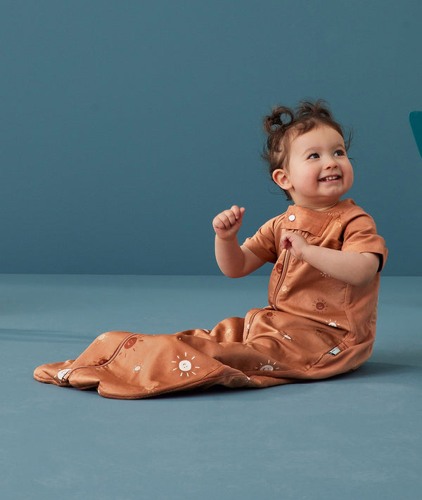 Toddler wearing an ergoPouch Sleep Suit Bag 1.0 TOG Sunny