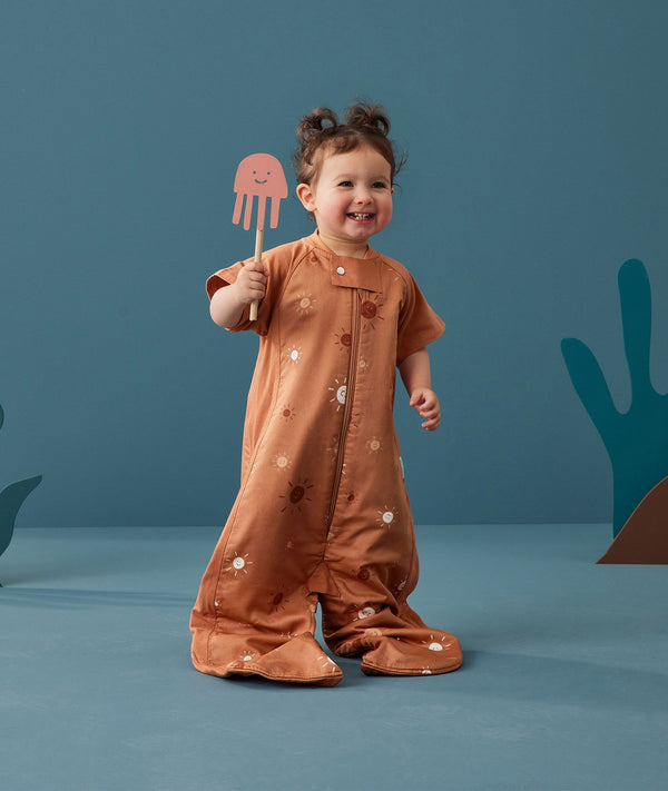 Toddler wearing an ergoPouch Sleep Suit Bag 1.0 TOG Sunny