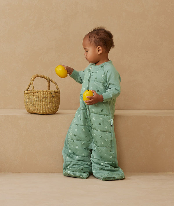 Toddler wearing a warm, ergoPouch Sleep Suit Bag 3.5 TOG Sweet Orchard