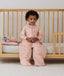 Toddler wearing a warm, ergoPouch Sleep Suit Bag 3.5 TOG Daisies