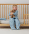 Toddler wearing an ergoPouch Sleep Suit Bag 2.5 TOG Dragonflies